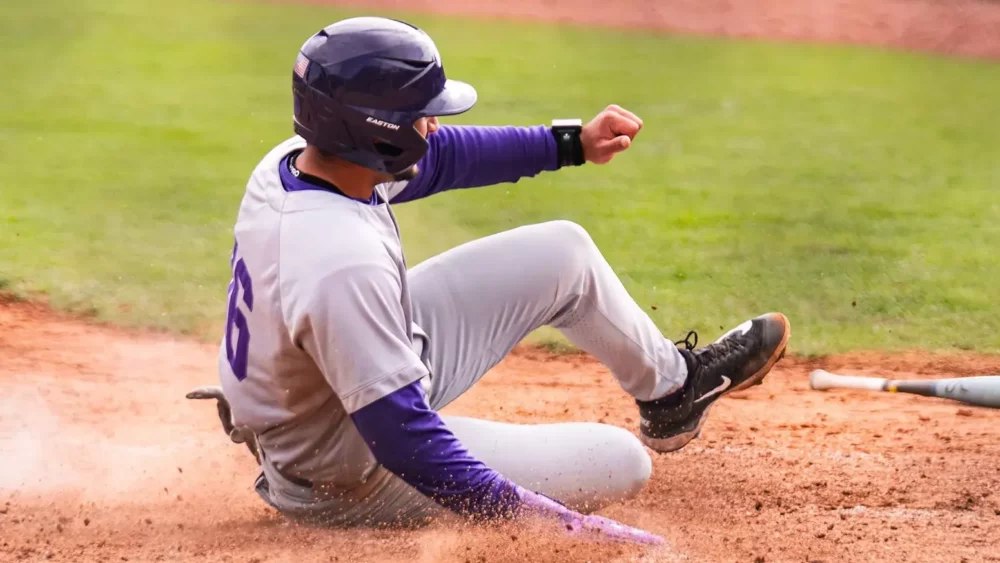UCA Bears Tate Greene slides across home plate in a game against the Bellarmine Knights
